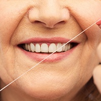 closeup of a smile with floss