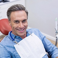 smiling man in the dentist’s chair for a checkup